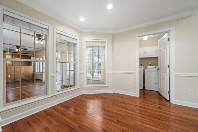 unfurnished dining area featuring baseboards, dark wood finished floors, ceiling fan, crown molding, and separate washer and dryer