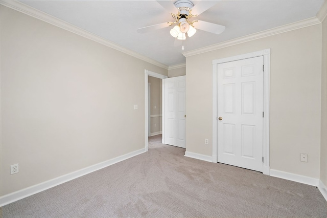 unfurnished bedroom with light carpet, crown molding, baseboards, and ceiling fan