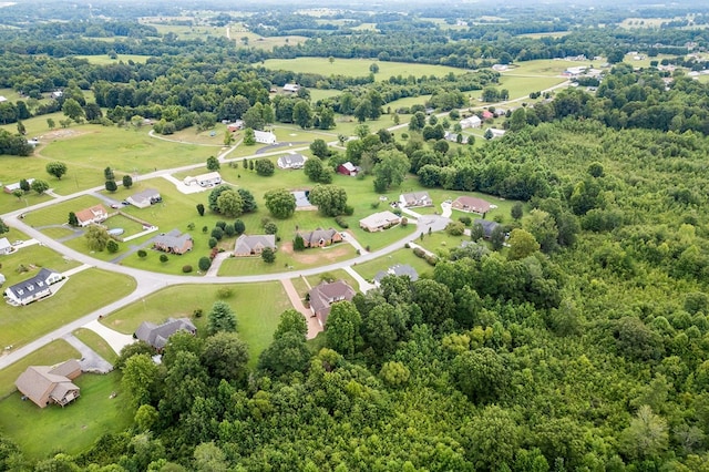 drone / aerial view featuring a forest view and a residential view