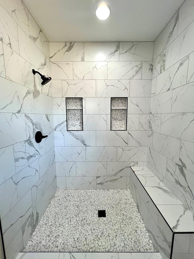 bathroom with a tile shower