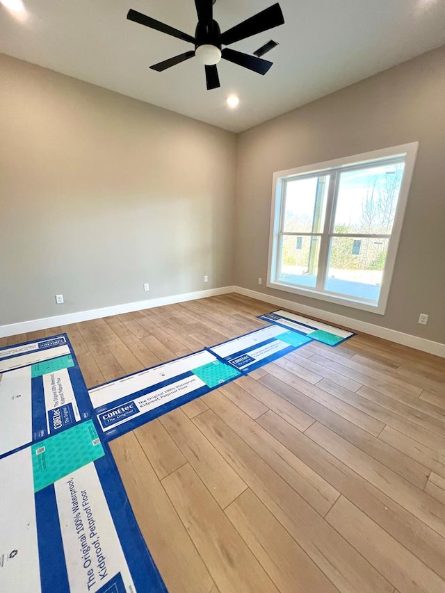 empty room with recessed lighting, ceiling fan, baseboards, and wood finished floors