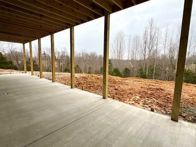 view of patio featuring a wooded view