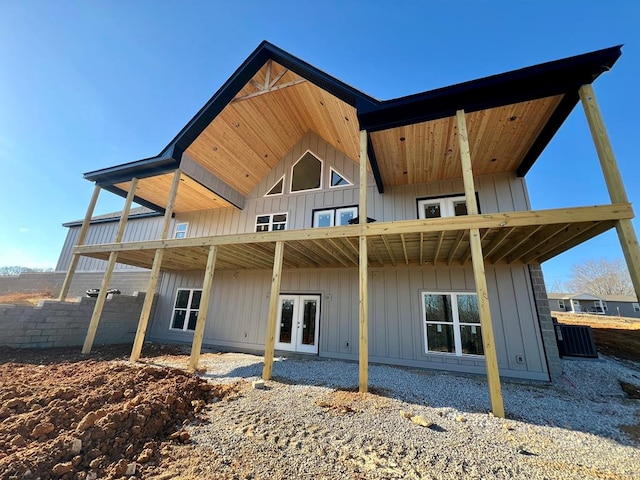 back of house with french doors and board and batten siding