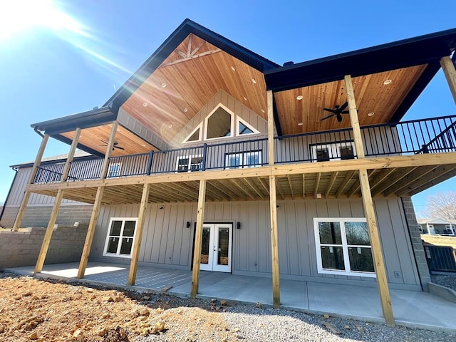 back of property featuring a patio, french doors, board and batten siding, a wooden deck, and ceiling fan