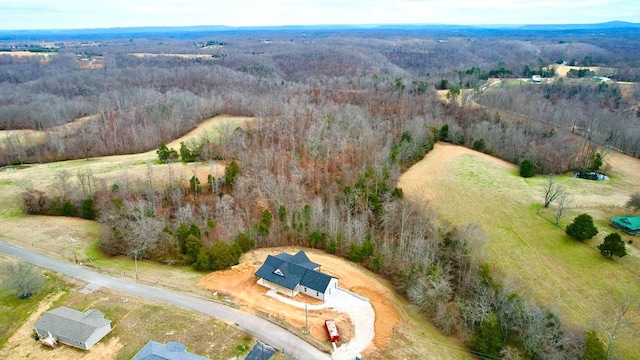 birds eye view of property with a wooded view