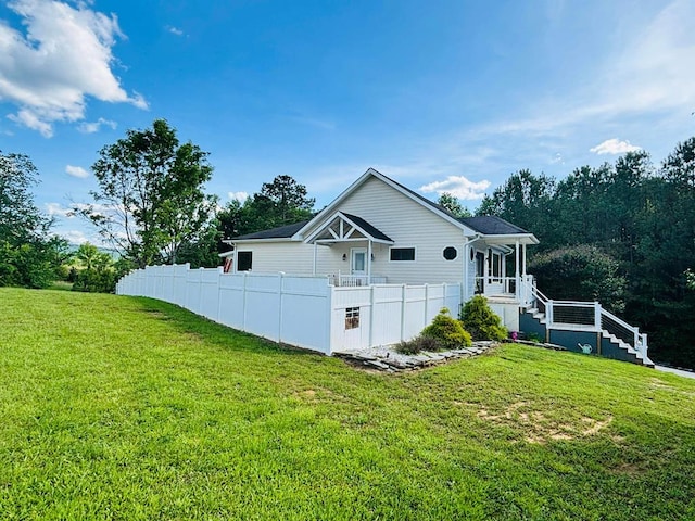 exterior space featuring fence and a yard