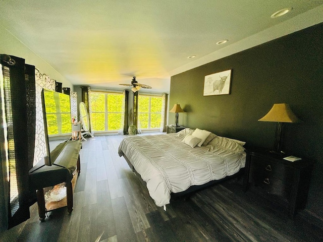 bedroom featuring lofted ceiling, ceiling fan, and dark wood-style floors