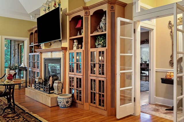 interior space featuring ornamental molding, a fireplace, and wood finished floors