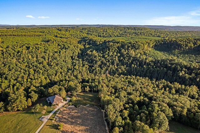 birds eye view of property with a view of trees