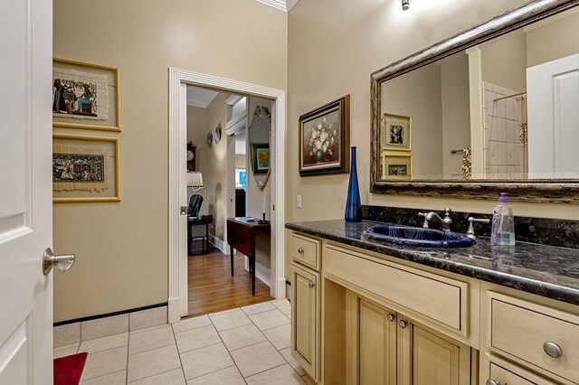 bathroom featuring tile patterned flooring, vanity, and baseboards