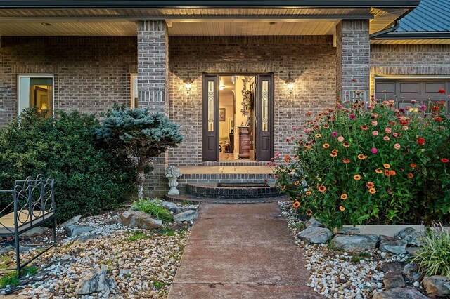 doorway to property with brick siding