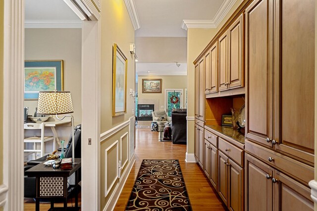 hallway featuring crown molding and light wood-style flooring