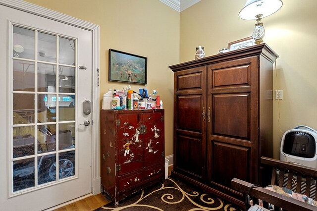 interior space with ornamental molding and dark wood finished floors