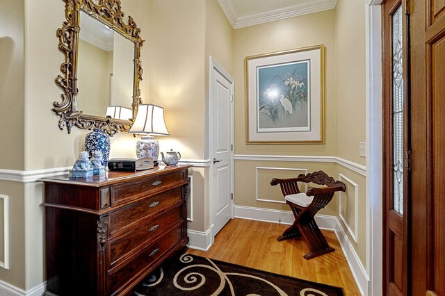 interior space with light wood-style flooring and ornamental molding