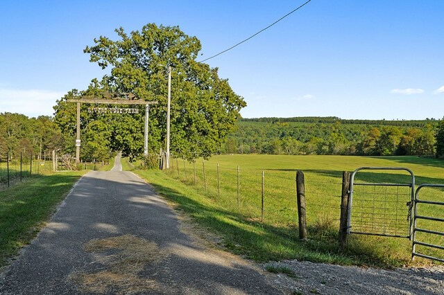 view of street with a forest view and a rural view