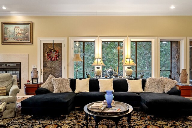 living room with ornamental molding, a fireplace, and recessed lighting