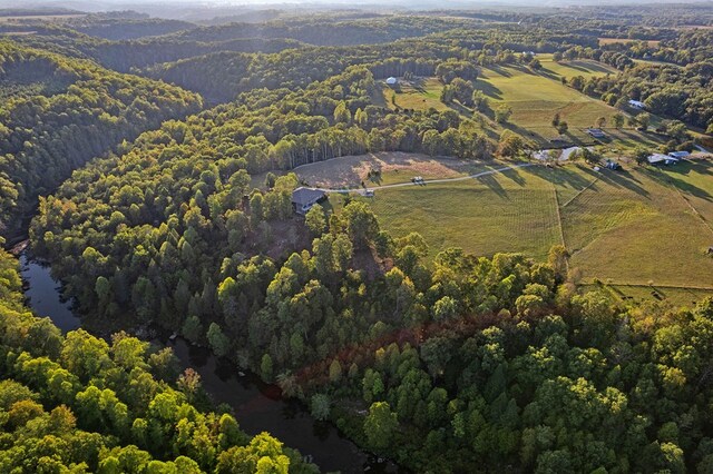 birds eye view of property featuring a view of trees and a rural view