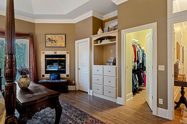 home office with ornamental molding, wood finished floors, and baseboards