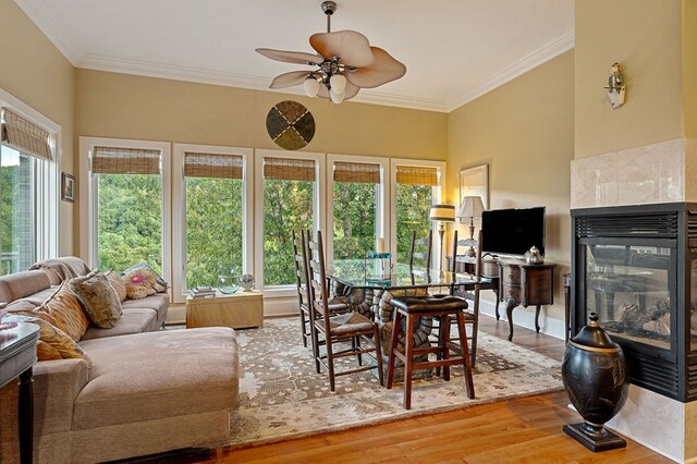 sunroom / solarium with a fireplace and a ceiling fan