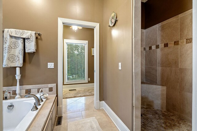 full bath with tile patterned flooring, a garden tub, visible vents, baseboards, and walk in shower