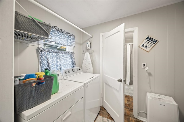 clothes washing area with laundry area, separate washer and dryer, and crown molding