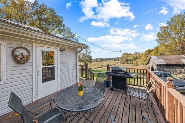 wooden deck featuring a grill