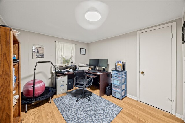 office space featuring wood finished floors and crown molding