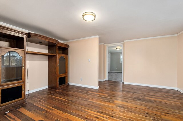 unfurnished living room with crown molding, baseboards, and dark wood-type flooring