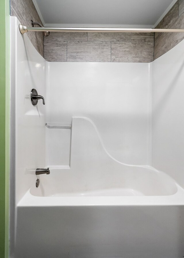 bathroom with shower / washtub combination