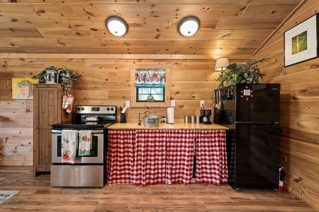 kitchen featuring wood finished floors, freestanding refrigerator, electric stove, wood walls, and wooden ceiling