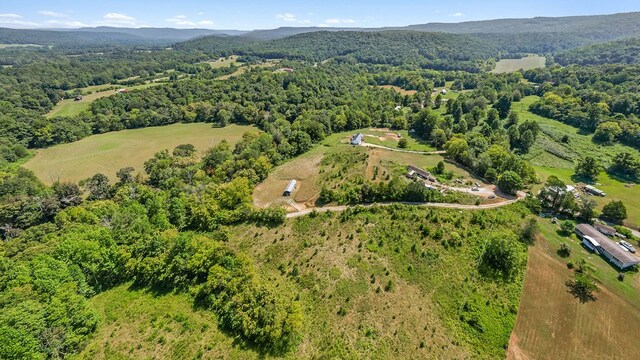 drone / aerial view featuring a wooded view