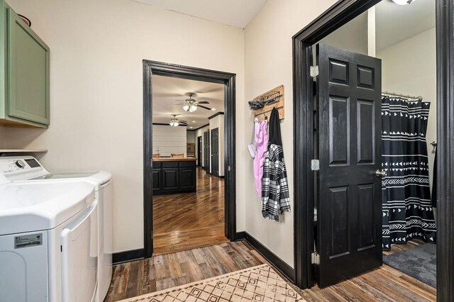 washroom with a ceiling fan, baseboards, cabinet space, dark wood-style floors, and washer and clothes dryer