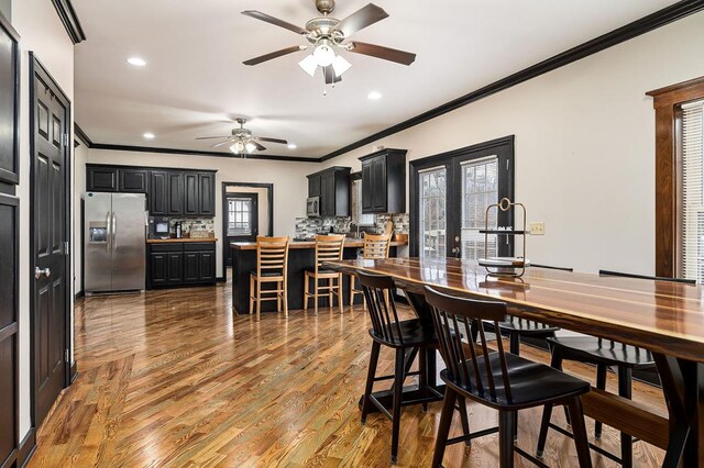 dining room featuring ceiling fan, ornamental molding, wood finished floors, and recessed lighting