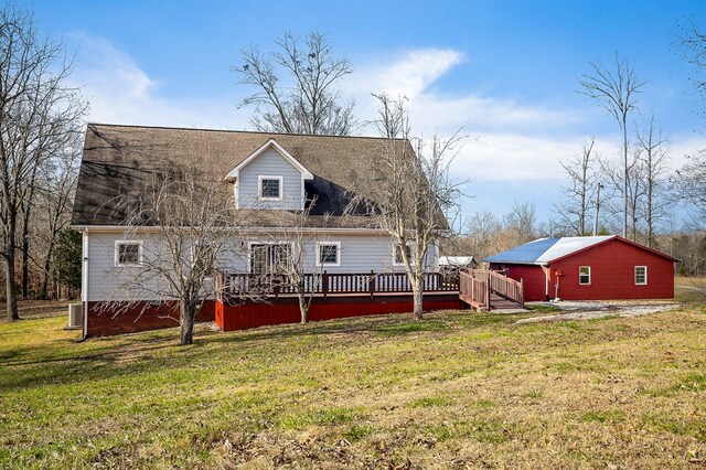 rear view of house featuring a lawn and a deck