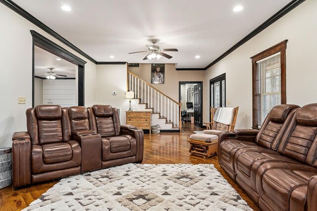 living area featuring stairway, recessed lighting, dark wood finished floors, and crown molding