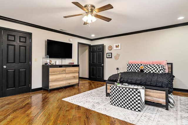 bedroom with crown molding, ceiling fan, dark wood finished floors, and baseboards