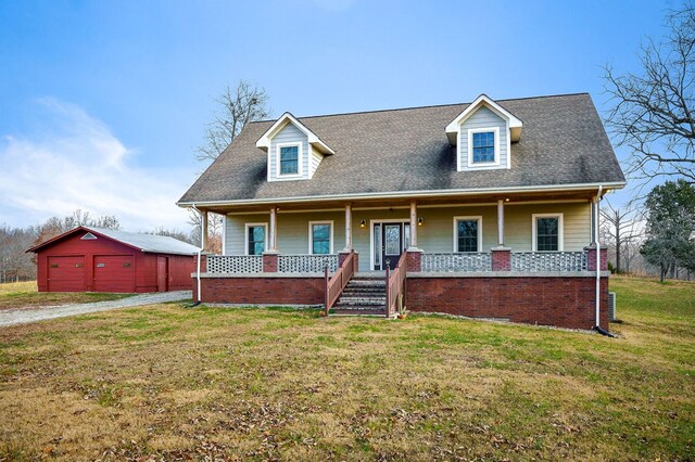 cape cod-style house with a garage, a porch, an outdoor structure, and a front yard