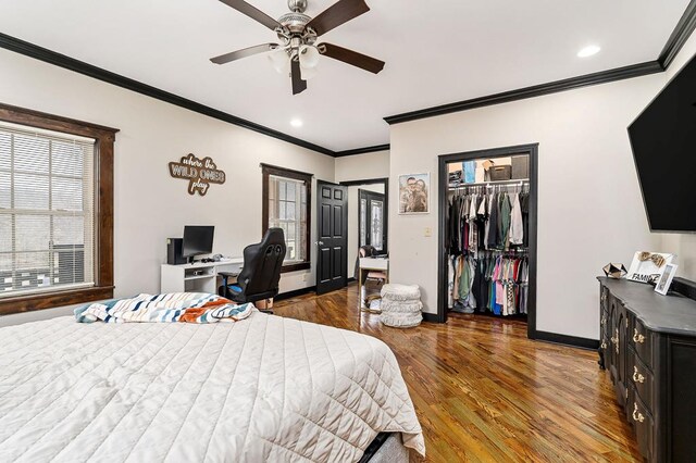 bedroom with ornamental molding, a closet, baseboards, and wood finished floors