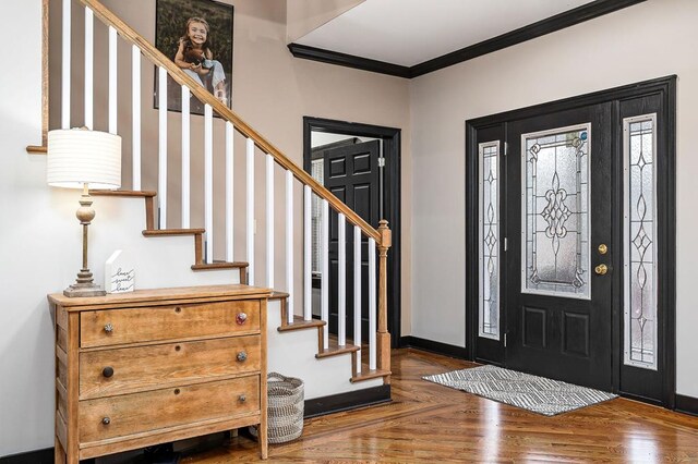 entrance foyer featuring parquet floors, stairs, baseboards, and crown molding