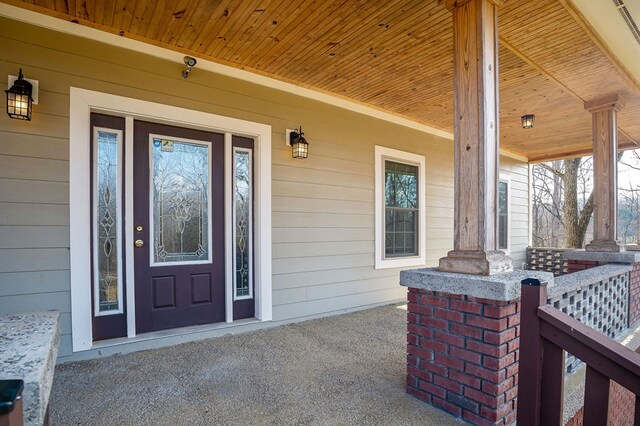 view of exterior entry with a porch