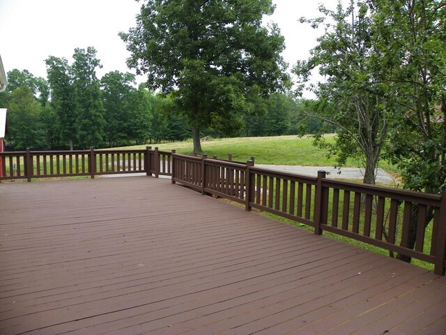 wooden terrace with a lawn