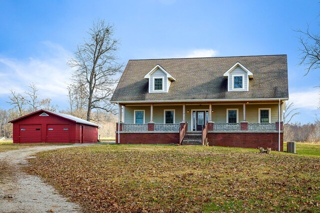 view of front of home with driveway, a garage, a porch, an outdoor structure, and a front lawn