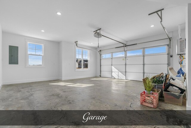 garage featuring a garage door opener, recessed lighting, electric panel, and baseboards