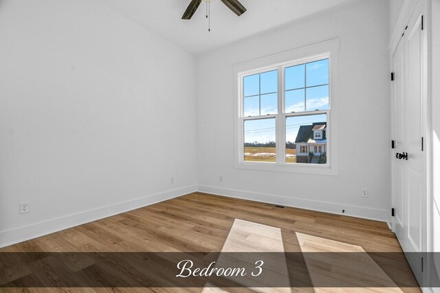 unfurnished bedroom featuring light wood finished floors, a ceiling fan, visible vents, and baseboards