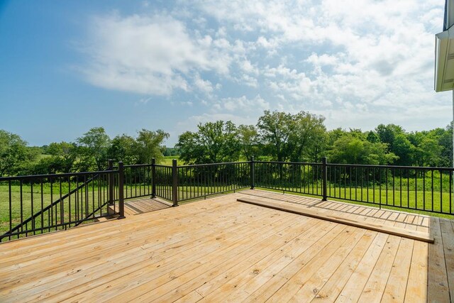 wooden deck featuring a yard