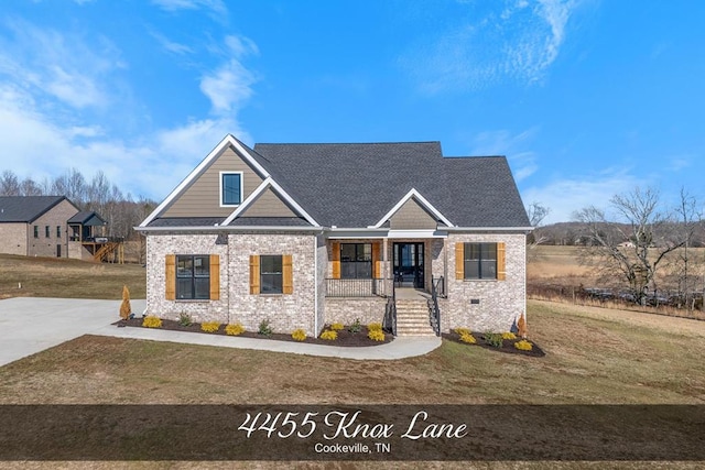 craftsman-style home with crawl space, brick siding, a porch, and a front yard