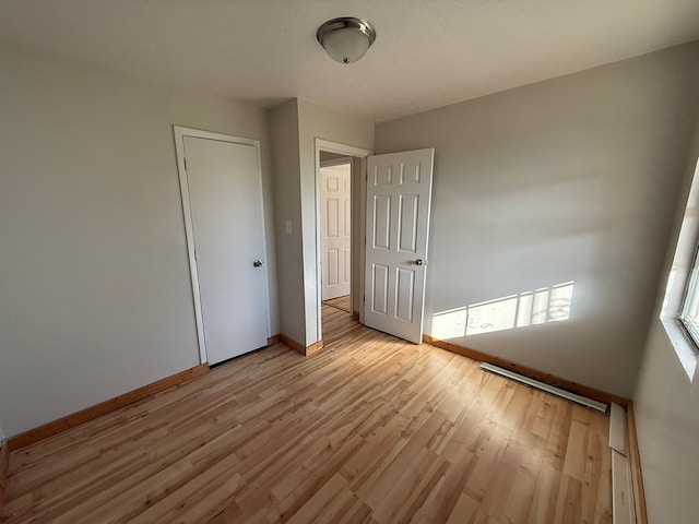 unfurnished bedroom with light wood finished floors and baseboards