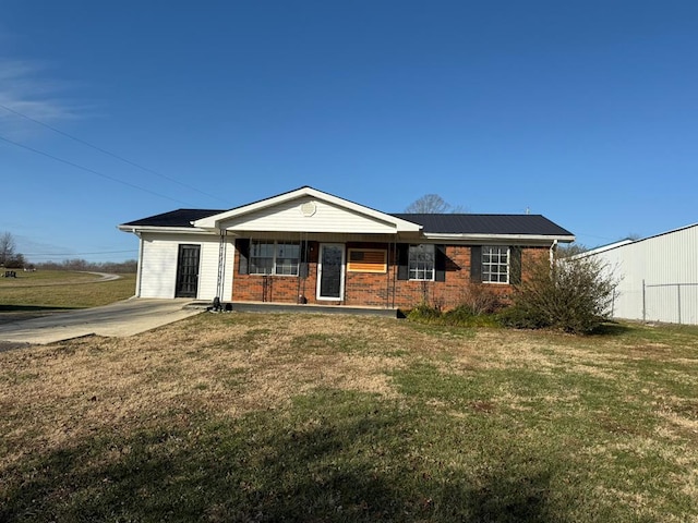 single story home featuring a porch, a front lawn, and brick siding