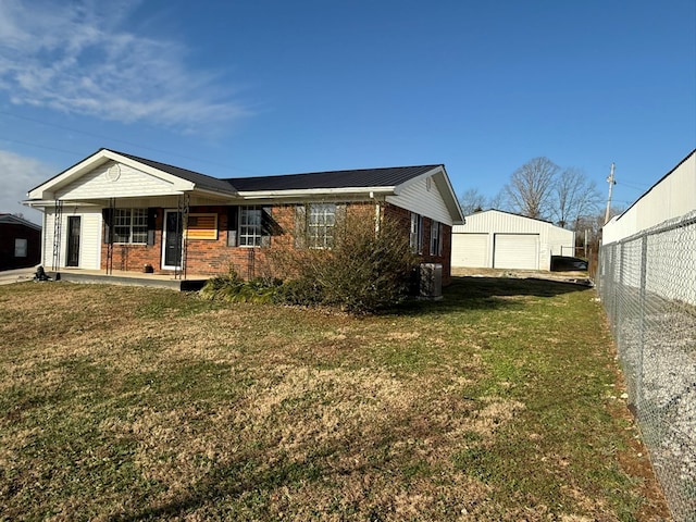 exterior space featuring a garage, brick siding, fence, and a front lawn