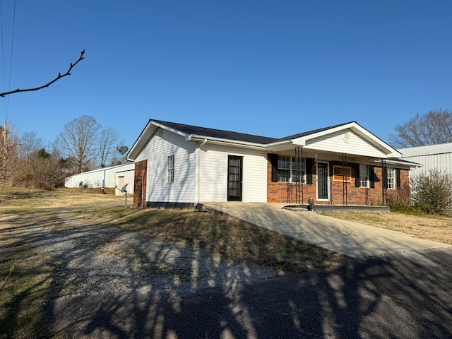 ranch-style house featuring a porch and brick siding